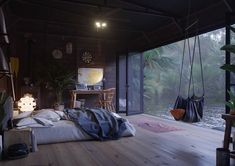 a bedroom with wooden floors and lots of plants on the wall, along with a hanging bed