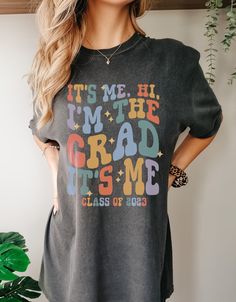 "🥳 Celebrate the Class of 2023 with our Comfort Colors 1717 Shirt: \"Hi, it's me. I'm the grad, it's me!\" This soft and breathable shirt is perfect for college or high school graduates. The bold message proudly displays your accomplishment, making it an ideal gift. Get yours today and embrace the comfort and pride of being a graduate. 👕 PRODUCT INFO The Comfort Colors 1717 shirt is made of 100% ring-spun cotton, pre-shrunk, and double-needle stitched for added durability. It offers a relaxed fit and a wide range of colors, and the pigment-dyed fabric gives the shirt a vintage, lived-in look. This shirt is budget-friendly, versatile and comfortable, making it a perfect choice for anyone looking for a durable t-shirt. ✏️ DESIGN Designs are printed onto the shirt using Direct to Garment (D Cheap Text Print T-shirt For College, Cheap Casual T-shirt For College Events, Cheap College Style T-shirt For School, Casual T-shirt For College, College Band Merch T-shirt With Letter Print, Fan Apparel T-shirt With Letter Print For Concert, Hi Its Me, High School Grad Gifts, Grad 2023