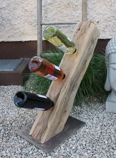 a wine rack made out of wooden planks with two bottles on it and a buddha statue in the background