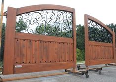 two wooden gates with wrought iron work on them