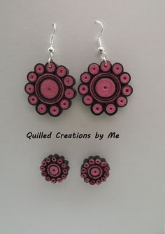 the earrings and earring are made out of polymer beads with pink circles on them