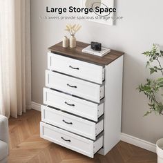 a white dresser with five drawers in front of a window and a potted plant