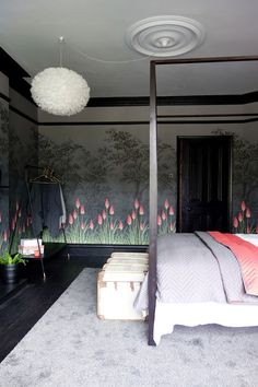 a bedroom with a canopy bed and wallpaper