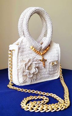 Luxury handmade crochet purse with 110 cm gold chain. Can be used as a crossbody or shoulder bag. Inside is carefully lined with cotton fabric. Perfect as a gift for any special occasion, stylish and also practical for carrying all your essentials with ease. Length: 8.5 inches Height: 11.5 inches with handle, 6 inches without handle  Width: 3 inches White Crochet Crossbody Bag For Gifts, White Crochet Crossbody Shoulder Bag, Elegant White Crochet Shoulder Bag, Crochet Luxury, Wedding Handbag, Luxury Crossbody, Crochet Purse, Bag Inside, Sling Bags