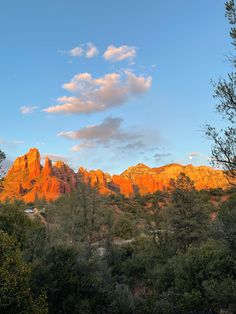 the sun is setting on red rocks in sedona