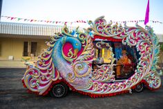 an elaborately decorated vehicle parked in front of a building