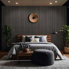 a large bed sitting next to a wooden table in a room with potted plants on the wall