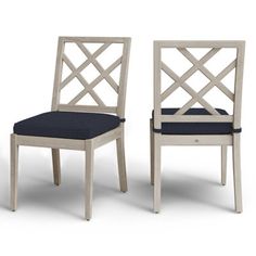 two white chairs with blue cushions on them