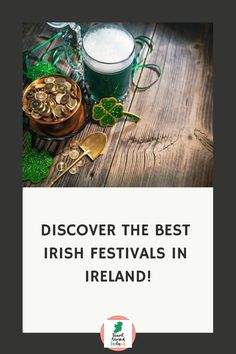 a wooden table topped with shamrocks next to a glass filled with beer and coins