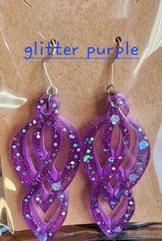 Handmade earrings made from resin. All products are uniquely made and differ in color pattern. Adorable handmade earrings. All earrings are handmade with resin and are unique in design. Dangle earrings come with a hook back and plastic stopper. Handmade Plastic Earrings As A Gift, Handmade Plastic Dangle Earrings, Purple Plastic Jewelry As Gift, Purple Resin Earrings As Gift, Purple Resin Earrings As A Gift, Purple Resin Earrings For Gift, Purple Resin Earrings Perfect For Gifts, Purple Plastic Jewelry Gift, Purple Resin Drop Earrings