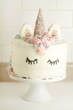 a cake decorated with sprinkles and unicorn ears