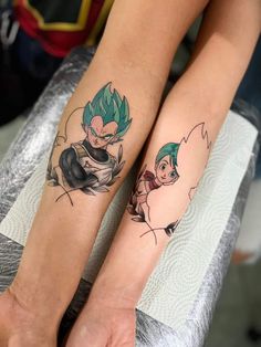 two people with tattoos on their legs sitting next to each other