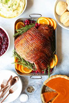 a turkey with oranges, cranberry sauce and mashed potatoes on the side