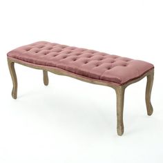 a pink bench sitting on top of a white floor