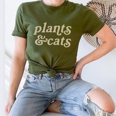 Cats And Plants Shirt, Plant Shirt, Gardener T-Shirt, Gift For Plant Lover, Cat Lover Shirt, Retro Plants Shirt, Plant Lady, Plant Mom Discover The Purr-Fect Blend Of Your Two Favorite Things With Our Cats & Plants Unisex T-Shirt! This Trendy And Comfortable Tee Is A Must-Have For Any Cat Lover And Plant Enthusiast. Made With High-Quality, Soft Bella Canvas, It Features A Charming Graphic That Creatively Combines Adorable Cats With Lush Green Plants. Available In A Variety Of Sizes And Popular C Plant Lady Outfit, Plant Tshirt Design, Plant Clothes, Plants And Cats, Plant Shirts, Cats Plants, Gardening Shirts Funny, Gift For Plant Lover, Plant Store