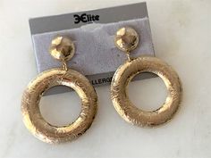 "Polished Gold Tone Floral Engraved Front Hoop Drop Pierced Earrings Hoops are Slightly Domed Earrings Measure 2 1/2\" Long x 1 3/4\" in Diameter The Round Tops are Hollow Domed and Measure 5/8\" in Diameter These Earrings are Very Light Weight Surgical Steel Hypo Allergenic Posts Gold Tone Backs Made in USA COMPLIMENTARY DOMESTIC SHIPPING" Elegant Etched Metal Earrings, Gold Etched Drop Earrings, Gold Etched Round Earrings, Elegant Etched Round Earrings, Gold Etched Dangle Jewelry, Earrings Hoops, Faceted Crystal, Pierced Earrings, Chain Link Necklace