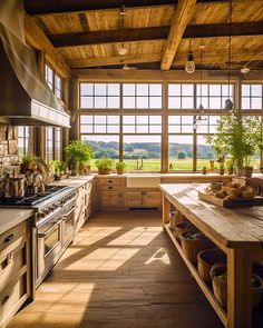 a kitchen with large windows and lots of counter space next to a stove top oven