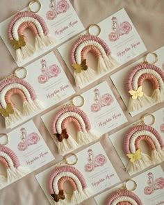 many pink and white tasselled items are arranged on a table with greeting cards