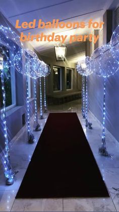 a hallway decorated with blue lights and decorations