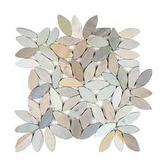 a pile of white and grey leaves on top of each other with some silver foil