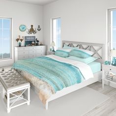 a bedroom with white walls and wooden floors is decorated in shades of blue, green and gray