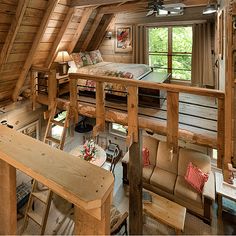 an attic bedroom with wooden walls and flooring is shown in this image, there are two lofted beds on the second floor