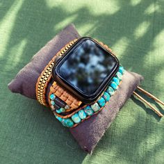 💙This stunning Apple watch band turns your watch into a stunning piece of jewellery. Made with natural stones such as Imperial Turquoise Jasper and Hematite, it helps find emotional balance and advance on your spiritual journey.  *The band wraps around your wrist 3 times and has 3 closures, to fit most wrists. The cord is 100% vegan 🌱   *The default size fits a 16-18cm wrist. If you need a special size, please contact me before ordering.  *Compatible with 38mm-44mm Apple watch face. *Materials Turquoise Crystal, Apple Watch Faces, Diy Bracelet Designs, Crystal Beads Bracelet, Nature Bracelets, Apple Watch Bands, Bracelet Designs, Apple Watch, Arm Band