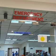 an emergency department sign hanging from the ceiling