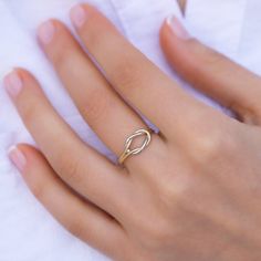 a woman's hand with a gold ring on it