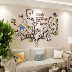 a living room with a couch, coffee table and family tree wall decal on the wall