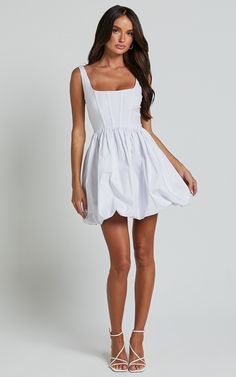 Get ready to turn heads in our Brianda Mini Dress - Corset Bodice Bubble Dress In White. This stunning white dress is perfect for any occasion, whether it's a party day or a casual day out. The corset bodice gives you that flattering fit and the bubble skirt adds a touch of fun to your look. Made from 100% cotton, this sleeveless mini dress is not only stylish but also comfortable to wear all day long. With its scoop neckline and fit-and-flare silhouette, this dress will make you feel confident and empowered wherever you go. So why wait? Add this must-have piece to your wardrobe today! Product Details: Fit & Flare Dress Scoop neckline Cotton fabric Sleeveless style Mini length dress Suitable for party day occasions Size and Fit Size S / 8 length: 84cm / 33.07in Material and Care Main Fabri White Ruched Corset Dress With Square Neck, White Ruched Corset Dress In Flirty Style, White Ruched Flirty Corset Dress, White Ruched Corset Dress With Flirty Style, White Ruched Corset Dress Flirty Style, White Corset Mini Dress With Fitted Bodice, White Bubble Dress For Spring Party, White A-line Ruched Mini Dress, White Square Neck Corset Dress For Summer