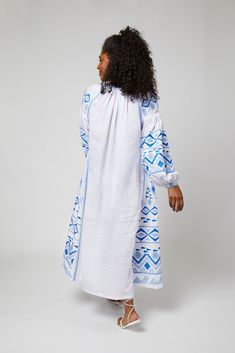 Daniela Ukrainian Embroidered Maxi Dress / Kaftan - White, Blue by Larkin Lane With its feminine shape and exquisite embroidery and details, the Daniela dress from Ukraine is a "one decision" outfit that speaks volumes about your style. The beauty of this textile tradition takes center-stage and can be paired with simple accessories, wedges, boots, or sandals. Versatile enough to go from sightseeing to celebrations; and did we mention... it has pockets?? Embroidery is a fundamental part of the U Traditional Blue Dress With Geometric Embroidery, Folk Style Long Sleeve Dresses For Daywear, Long Sleeve Folk Dresses For Daywear, Traditional Blue Dress With Embroidered Sleeves, Embroidered Tunic Dress For Daywear, Blue Embroidered Dress With Embroidered Sleeves, Traditional Embroidered Daywear Dresses, Blue Peasant Maxi Dress, White Peasant Dress With Geometric Embroidery