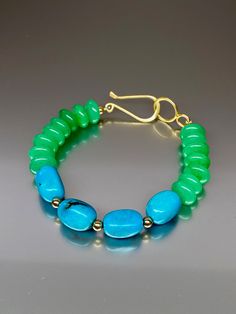 Beautiful chrysoprase green chalcedony and Mexican nacozari turquoise bracelet. The gorgeous color combination of fine quality vivid blue Mexican nacozari turquoise with chrysoprase green chalcedony creates a colorful bracelet. A small 14k gold-filled beads were added in-between the green chalcedony beads ending with a gold vermeil clasp. The necklace Length (with clasp)is about 8 inches long. Chic and colorful bracelet. *Metal: 14K Goldfilled, vermeil (over sterling silver) *Earrings drop lengt Green Agate Bracelets With Natural Stones, Turquoise Jade Gemstone Bracelet, Turquoise Jade Bracelet, Turquoise Gemstone Beaded Bracelets In Jade, Turquoise Jade Beaded Bracelets, Turquoise Jewelry With Natural Stones In Green Onyx, Turquoise Jewelry With Natural Green Onyx Stones, Green Cabochon Bracelets As A Gift, Green Cabochon Bracelets For Gift