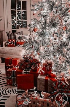 a decorated christmas tree with presents under it