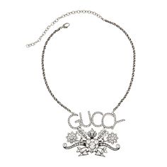 The Gucci GUCCY Crystal Necklace in Silver is crafted of aged, silver-tone metal in Italy. This crystal encrusted necklace features the GUCCY logo, a swirling flower design, a twist, and corded style chain. The back has the Gucci logo and delicate line work detailing. Silver GUCCY Crystal Necklace100% silver-tone metal Necklace, jewelryGUCCY logo Flower design Crystal encrusted Adjustable twist, corded chain Line work and Gucci logo on backLobster style clasp3.25" x 2.5" pendant Chain drop 15.5" Vintage Style Silver Gucci Jewelry, Designer Silver Gucci Jewelry, Vintage Silver Necklace With Logo Charm, Gucci Metal Chain Jewelry, Vintage Silver Gucci Jewelry, Gucci Silver Pendant Jewelry, Silver Gucci Necklace As Gift, Gucci Silver Chain Jewelry, Silver Gucci Necklace For Gift