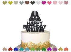 a star wars themed birthday cake with a darth vader topper on it