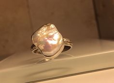 A personal favorite from my Etsy shop https://www.etsy.com/listing/268388413/upcycled-handcrafted-biwa-pearl-and Silver Mother Of Pearl Ring For Gift, Silver Mother Of Pearl Ring As Gift, Silver Pearl Ring With Mother Of Pearl As Gift, Silver High Luster Pearl Ring For Gift, Silver Pearl Ring With High Luster For Gift, Ring Pearl Modern, Silver Crown Ring, White Pearl Ring, Healing Crystal Ring