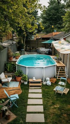 an above ground swimming pool with steps leading up to it and chairs around the pool