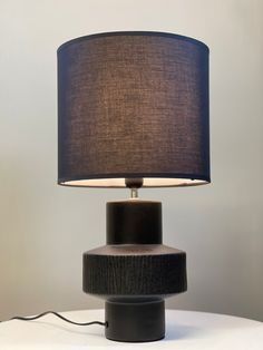 Bold Black Ceramic Table Lamp – Textured Base & Fabric Shade - Decor interiors Lamp With Black Shade, Minimalist Spaces, Monochromatic Design, Stylish Table Lamps, Ceramic Table Lamp, Black Table Lamps, Ceramic Base, Black Shade, Ceramic Lamp