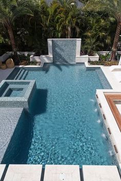 an outdoor swimming pool with steps leading to it and trees in the backgroud