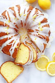 a lemon bunt cake with white icing and sliced lemons