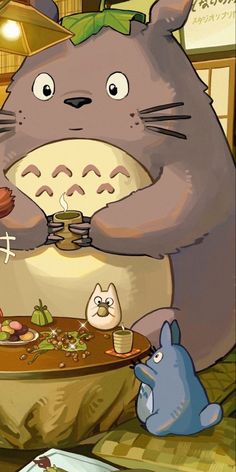 an animated image of a totoro eating at a table with other food items