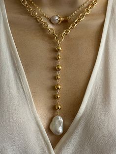 Statement pearl necklaces. Sold separately. 1. pearl Lariat features gold plated stainless steel oval link chain and combination of 8mm and 6mm gold plated stainless Steel beads. Coated large baroque pearl. Pearl size approximately 22mmx15mm. Necklace length around the neck is adjustable 16.5-18.5 inches. Drop 5 inches. 2. Claw charm features gold plated stainless steel claw charm and small baroque pearl. 18k rolo chain. Adjustable length 16-18 inches. 🎁All orders are shipped in a gift box. Gold Baroque Pearl Pendant Chain Necklace, Gold Baroque Pearl Pendant Necklace, Gold Chain Necklace With Baroque Pearl Pendant, Gold Baroque Pearl Lariat Necklace, Chunky Chain Pearl Necklace For Gift, Pearl Necklace With Chunky Chain For Gift, Gold Pearl Necklace With Chunky Chain, Lariat Necklace With Baroque Pearl Chain, Baroque Pearl Lariat Necklace With Pearl Charm