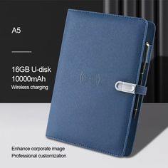 an image of a blue leather notebook with the cover open and it is being held by a metal clip