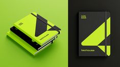 two notebooks sitting next to each other on a green and black background