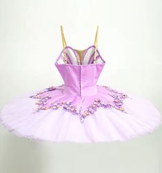 Professional pancake tutu designed for roles such as The Lilac Fairy. Satin lilac bodice with V neck and nude insert. Rich decoration with lilac and pink flower appliques, and rhinestones. Ten layers professional, white tutu skirt with flower shaped lilac tutu skirt, with decorations matching the bodice. Custom made. Delivery time: 6 to 8 weeks $ 630 Fitted Tulle Tutu Dress With Floral Applique, Fitted Lavender Tulle Tutu Dress, Lavender Princess Style Tutu Dress, Fitted Lavender Princess Tutu Dress, Fitted Princess Style Lavender Tutu Dress, Purple Fairy Style Tutu Dress, White Tutu Skirt, Lilac Fairy, Pancake Tutu