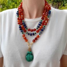 Orange agate,  lapis lazuli and malachite layered necklace with pendant. Chunky statement natural gemstone beaded necklace for women. Large orange blue green handmade necklace with big bead and gemstone. Big bold bohemian bright necklace in gold color are suitable for an casual look, evening look and for a holiday. These necklace will be a good Mothers day, anniversary, wedding or birthday gift for women, mom, wife, girlfriend, sister or daughter. Women's necklace with natural stone. It emphasiz Bold Bohemian, Bright Necklace, Apatite Necklace, Malachite Necklace, Women's Necklace, Chunky Statement Necklace, Orange Agate, Tigers Eye Necklace, Bold Necklace