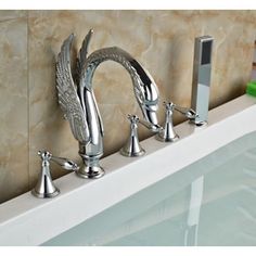 the faucet is attached to the wall above the bathtub, which has been decorated with angel wings