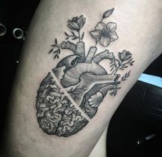 a black and white photo of a human heart with flowers on it's side