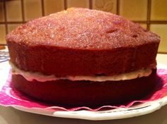 a cake sitting on top of a white plate next to a pink and white napkin